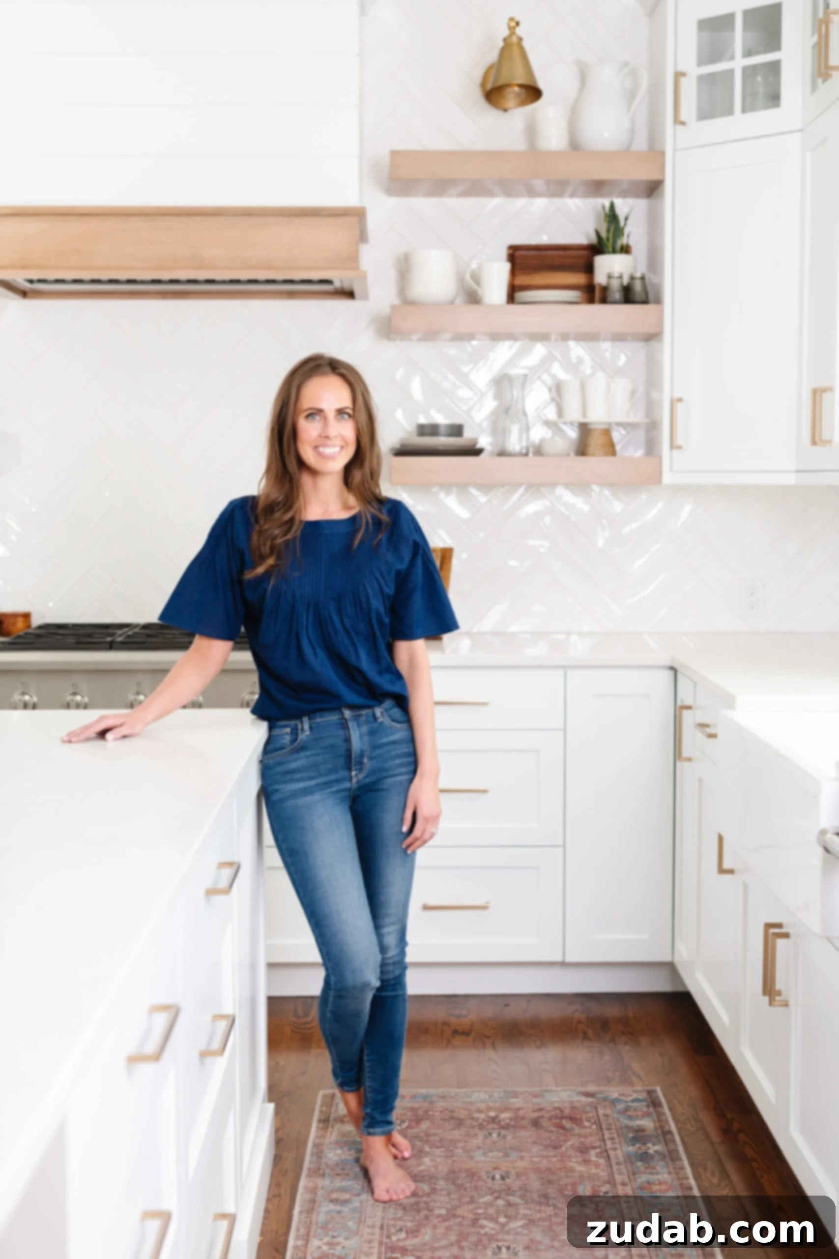 More Than Code 2 A woman smiling in her kitchen, embodying a genuine and authentic presence.