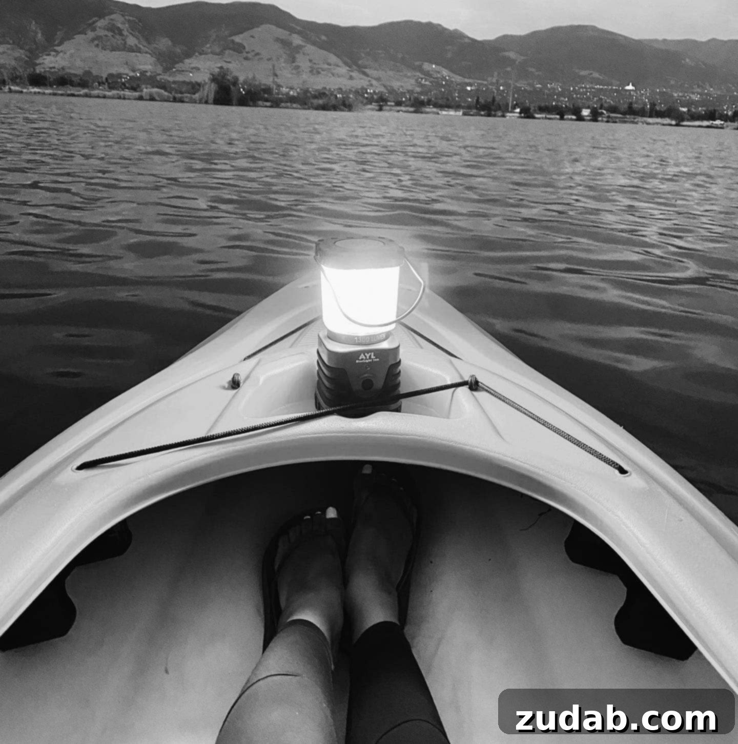 More Than Code 3 A serene night scene with a kayak illuminated by soft, ambient light on calm water, reflecting a gentle glow.