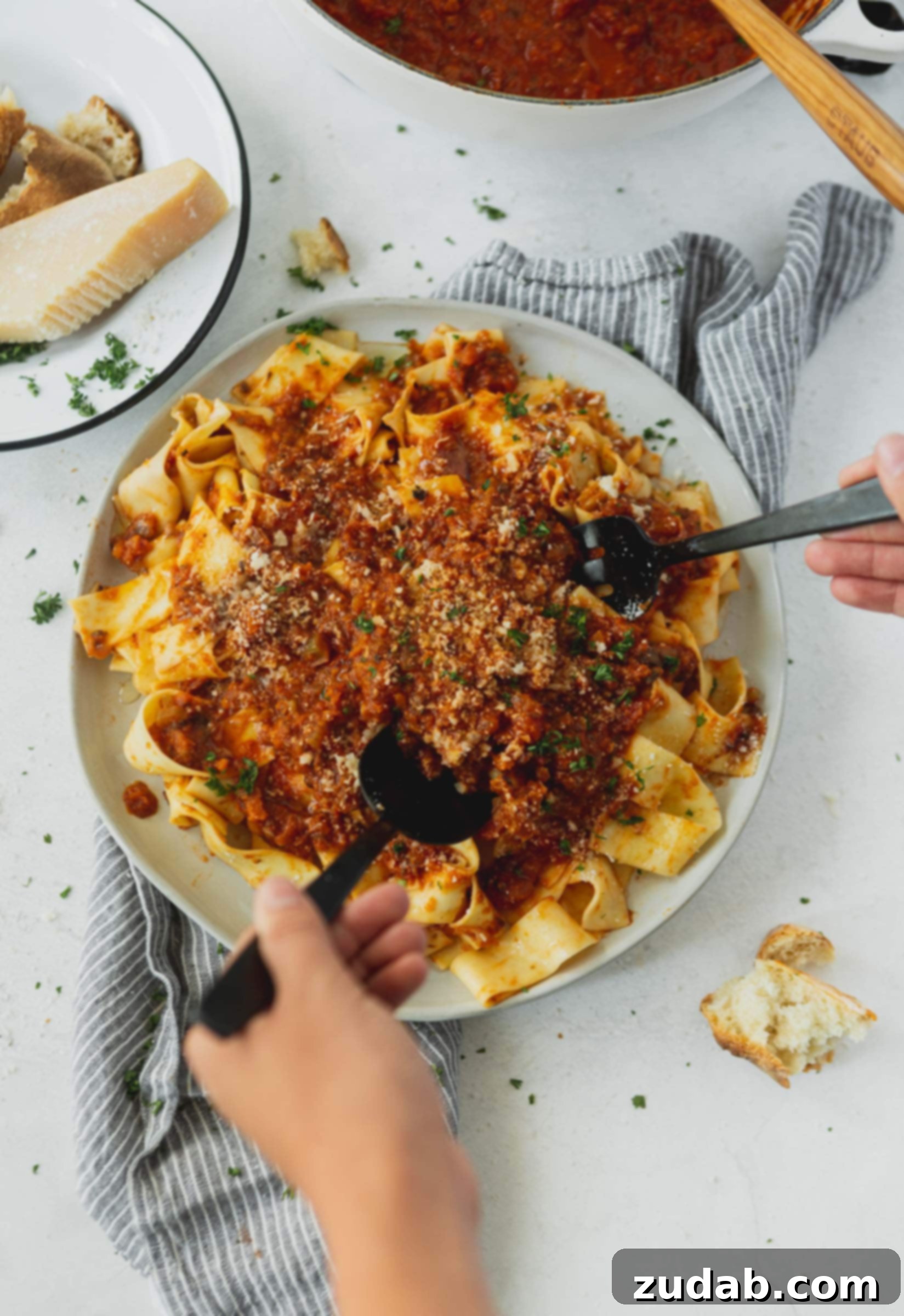 Hearty Vegan Bolognese Pasta A plate generously filled with pasta, crowned with a rich, savory vegan bolognese sauce, ready to be enjoyed.