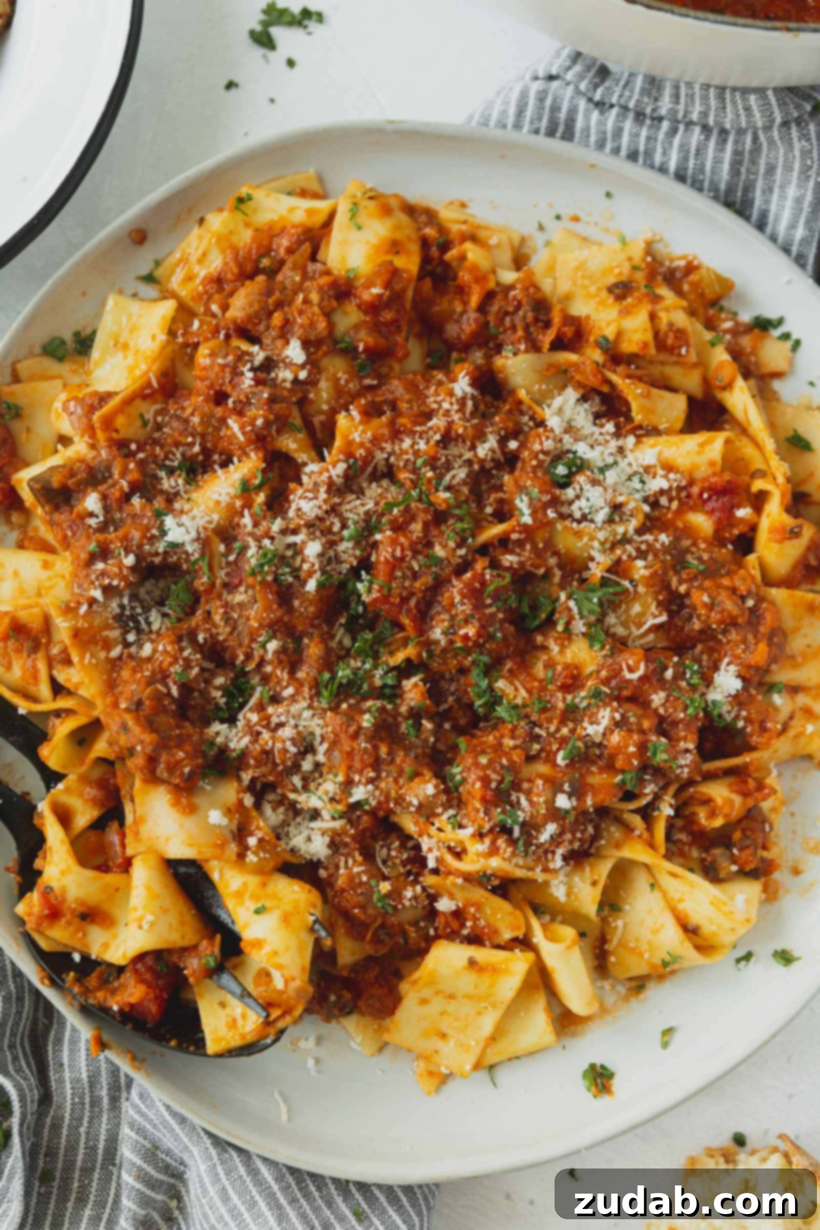 Delicious Bolognese Ready to Serve Pasta with vegan bolognese sauce, topped with a sprinkle of grated cheese (optional) and fresh chopped cilantro for garnish.