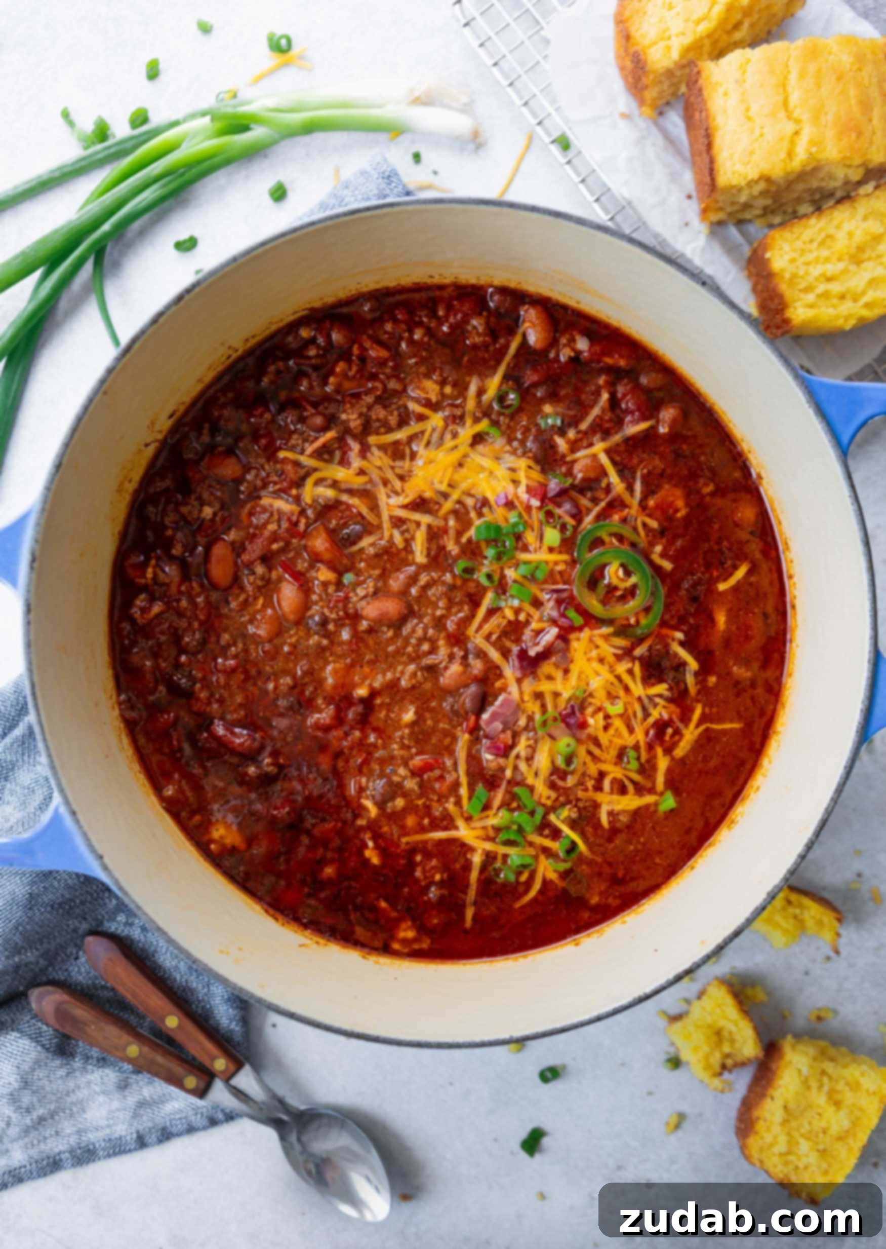 Best Chili Recipe A bowl of Best Chili topped with grated cheese and cilantro.
