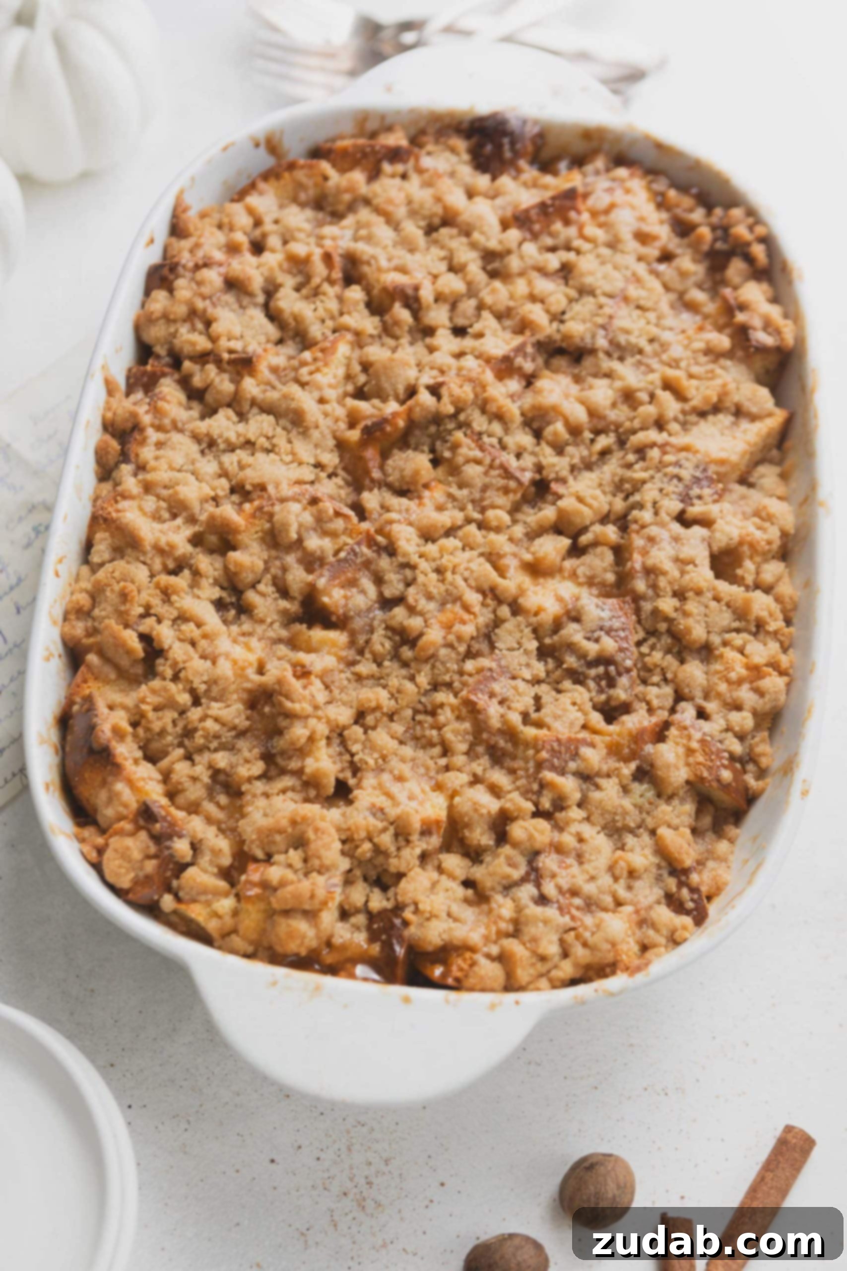 Eggnog French Toast Casserole A casserole dish with eggnog french toast. The French toast is topped with a crumb topping.