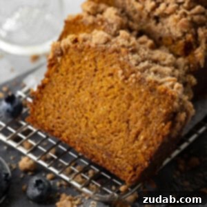 A freshly baked loaf of Cinnamon Crumb Pumpkin Bread, ready to be served.