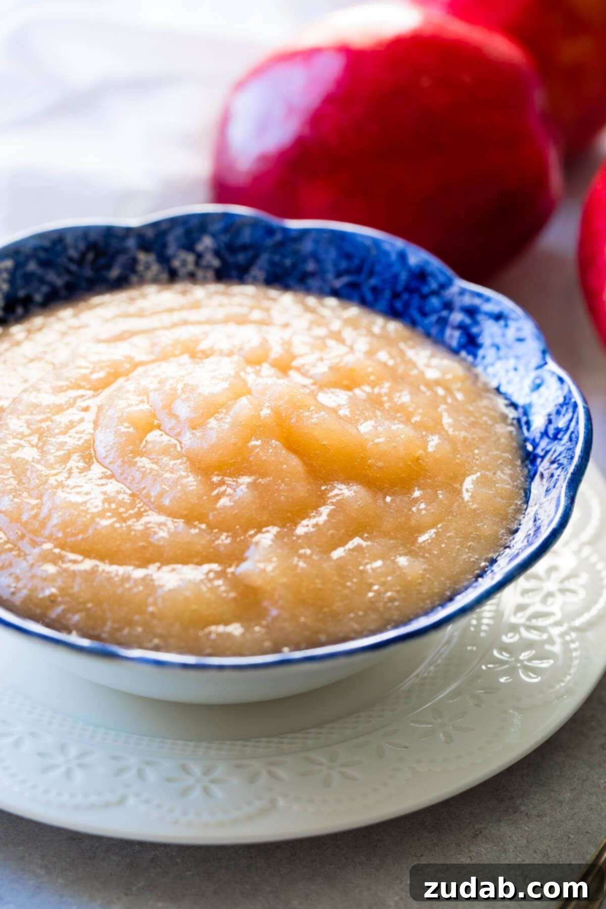 Over 25 Healthy Recipes 21 A bowl of freshly made two-ingredient Instant Pot applesauce, garnished with cinnamon sticks and a sprinkle of cinnamon.