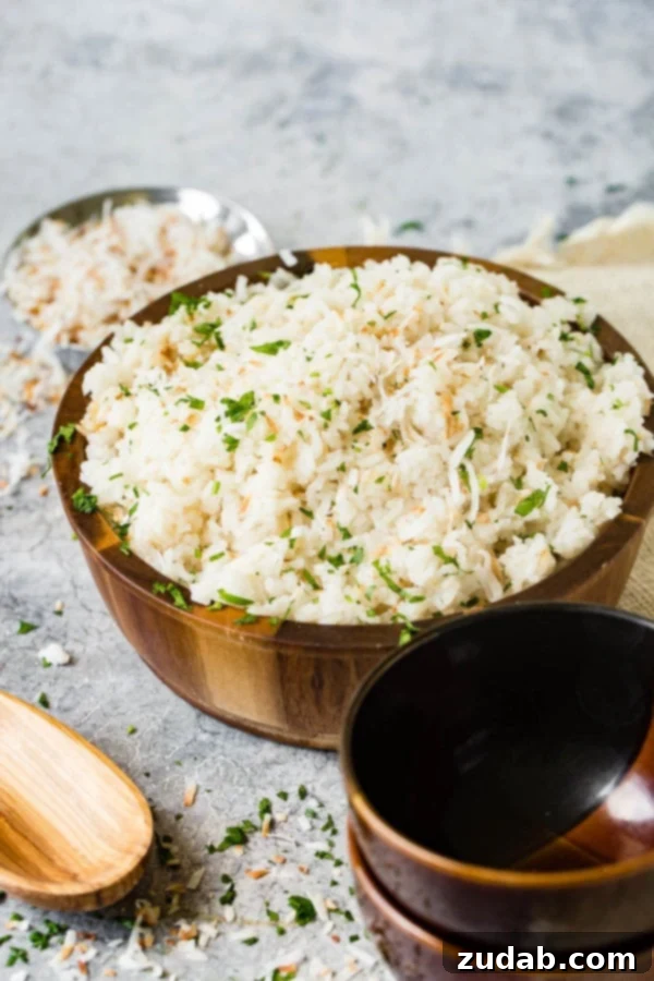 Brazilian Coconut Rice A photo of Brazilian coconut rice in a large wooden bowl and garnished with chopped fresh cilantro.