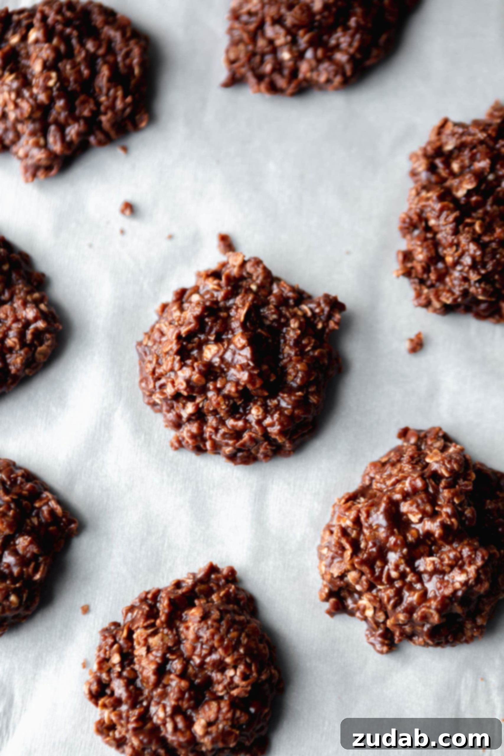 No bake cookies on a piece of parchment paper. They are chocolate and you can see the oats.