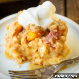 A top-down shot of a fully baked Peach Cobbler French Toast Casserole with a perfect golden crust.