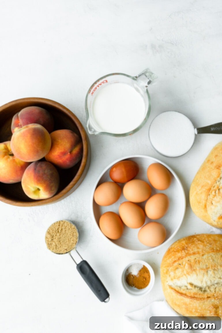 Delicious Peach Cobbler French Toast 4 A photo of all the ingredients for peach french toast casserole, including a bowl of fresh peaches, brown eggs, brown and white sugar, a loaf of bread, and cream, neatly arranged on a counter.