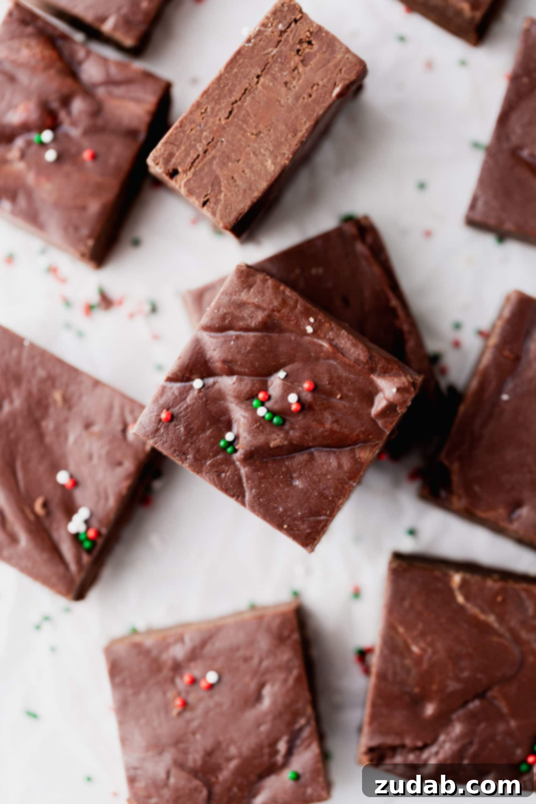 Fudge Storage Tips A plate of homemade fudge. The fudge is cut into squares and has a few red and green sprinkles on top.
