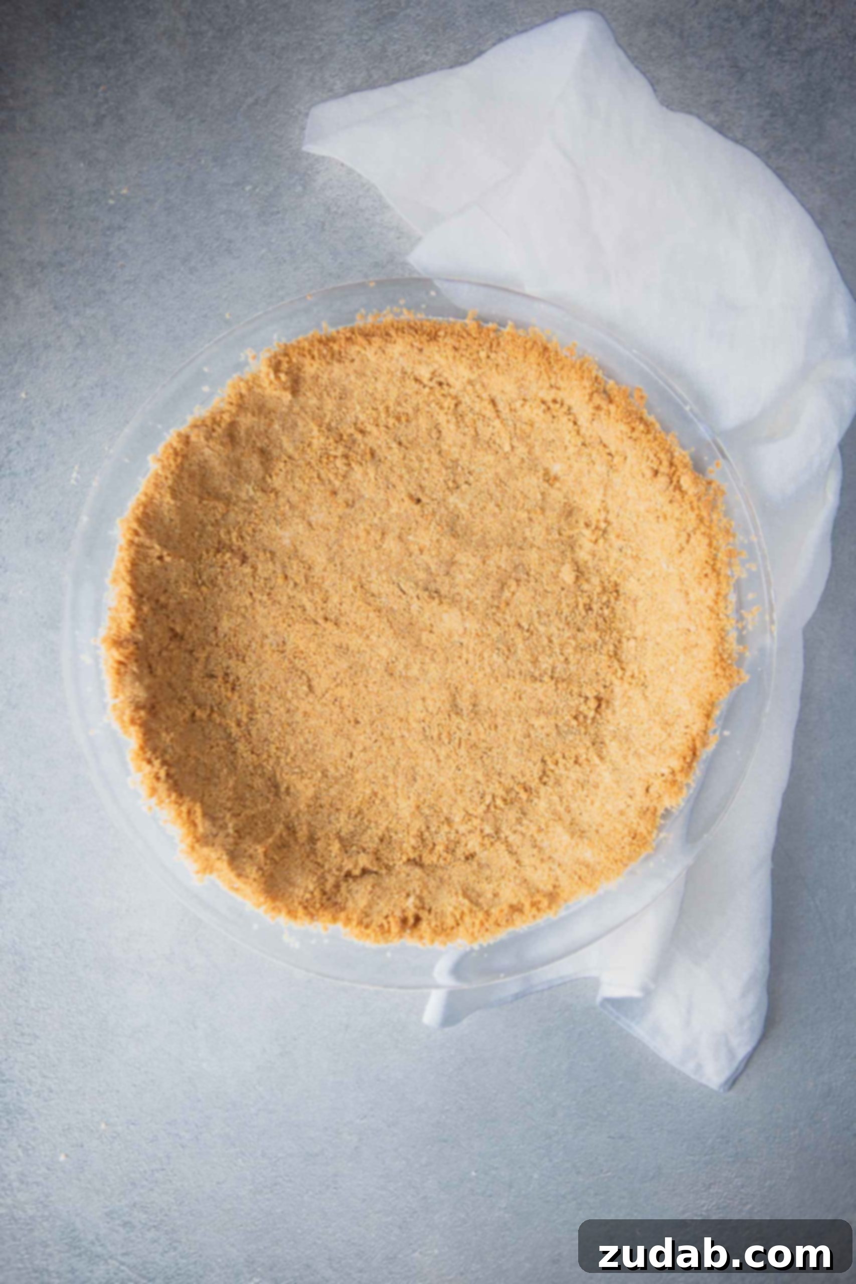 Homemade Graham Cracker Crust A perfectly pressed graham cracker crust in a pie dish, ready for baking.