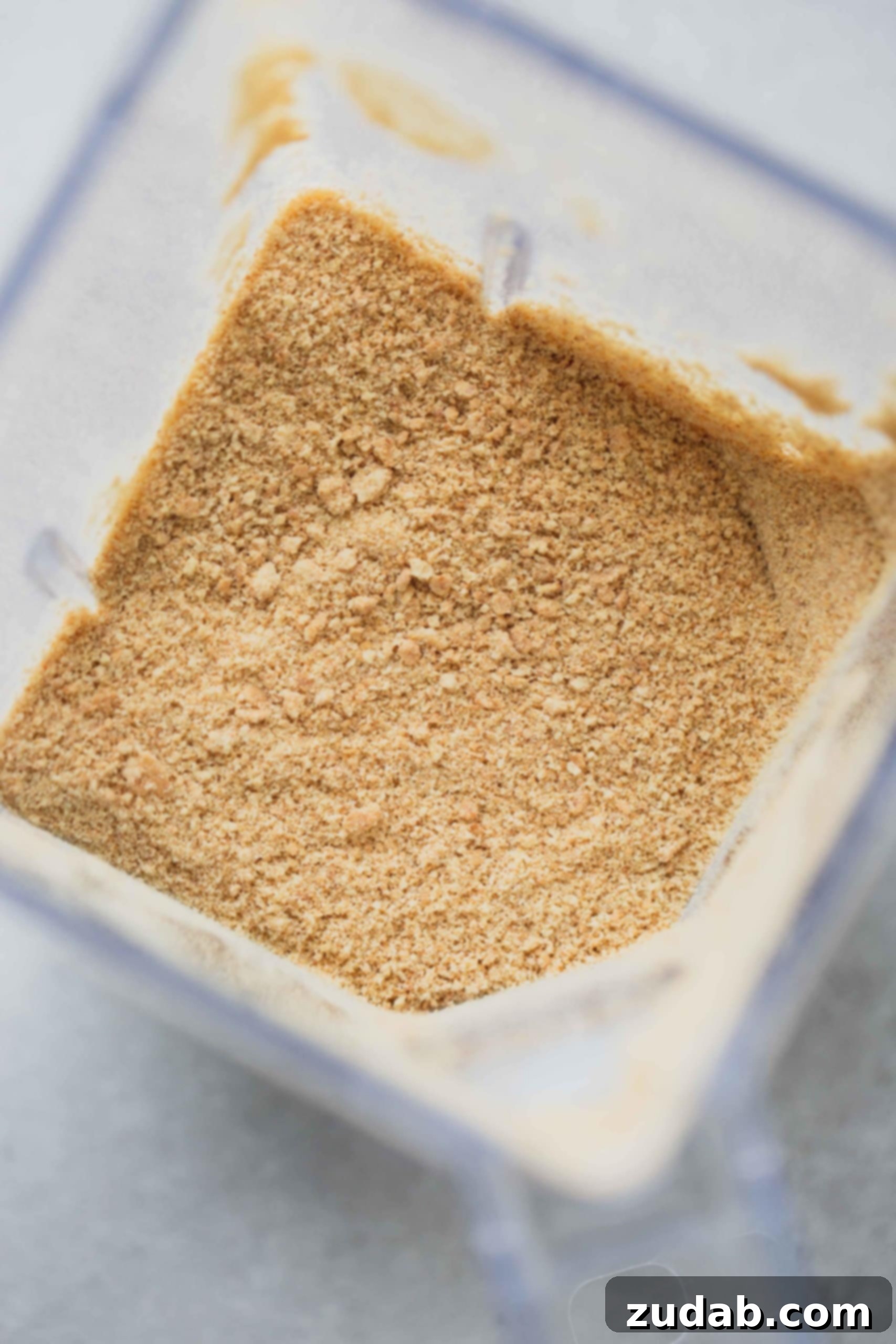 Making Graham Cracker Crumbs Graham cracker crumbs are shown in a blender container, perfectly crushed and ready for use in a pie crust.