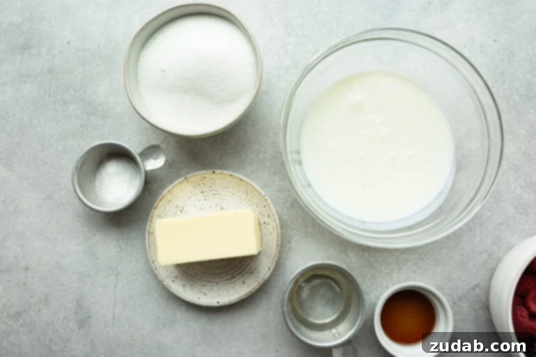 A beautifully arranged selection of buttermilk syrup ingredients in individual bowls: a stick of unsalted butter, white granulated sugar, liquid buttermilk, a vial of vanilla extract, a small container of corn syrup, and a spoon of baking soda.