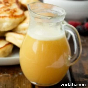 A rustic image of rich buttermilk syrup, ready to be poured over a hearty breakfast.