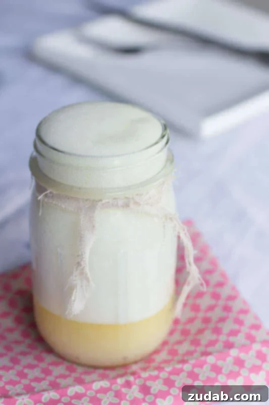 Close-up of golden buttermilk syrup glistening on a spoon, illustrating its rich texture and appeal.