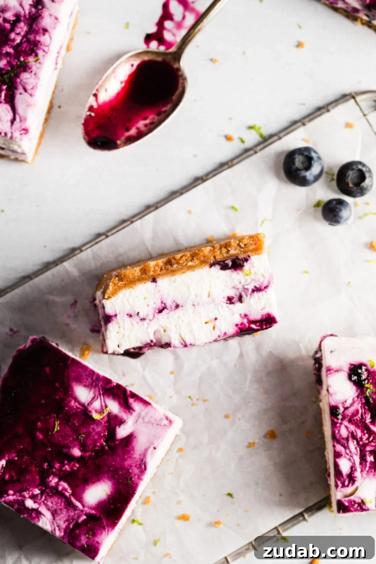 Luscious No-Bake Blueberry Lime Cheesecake Bars 4 Slice of no-bake blueberry lime cheesecake bar showing layers