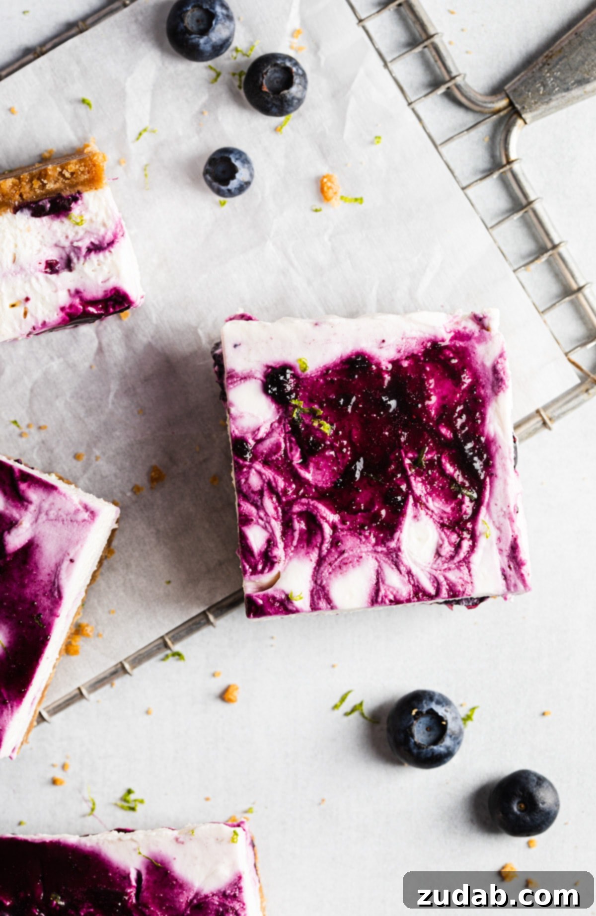 Luscious No-Bake Blueberry Lime Cheesecake Bars 6 Close-up of a single no-bake blueberry lime cheesecake bar slice