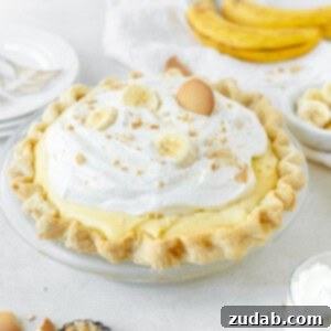 Heavenly Homemade Banana Cream Pie 2 A charming square photo of a homemade banana cream pie, invitingly topped with whipped cream and fresh fruit.