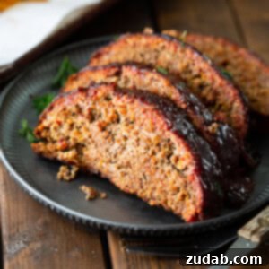 Ultimate Smoked Meatloaf 2 A delectable close-up of a perfectly cooked smoked meatloaf, showcasing its rich glaze and inviting texture.