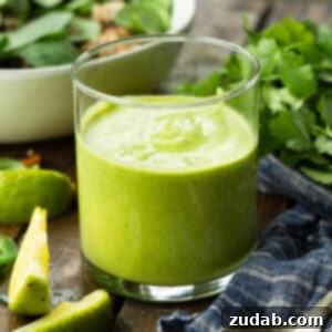 Fresh Creamy Avocado Cilantro Lime Dressing 4 A vibrant green avocado cilantro lime dressing in a glass jar, ready to be served.