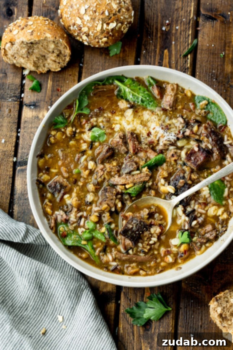 An inviting overhead photo of a bowl filled with our delicious beef barley soup, ready to be enjoyed with a spoon.