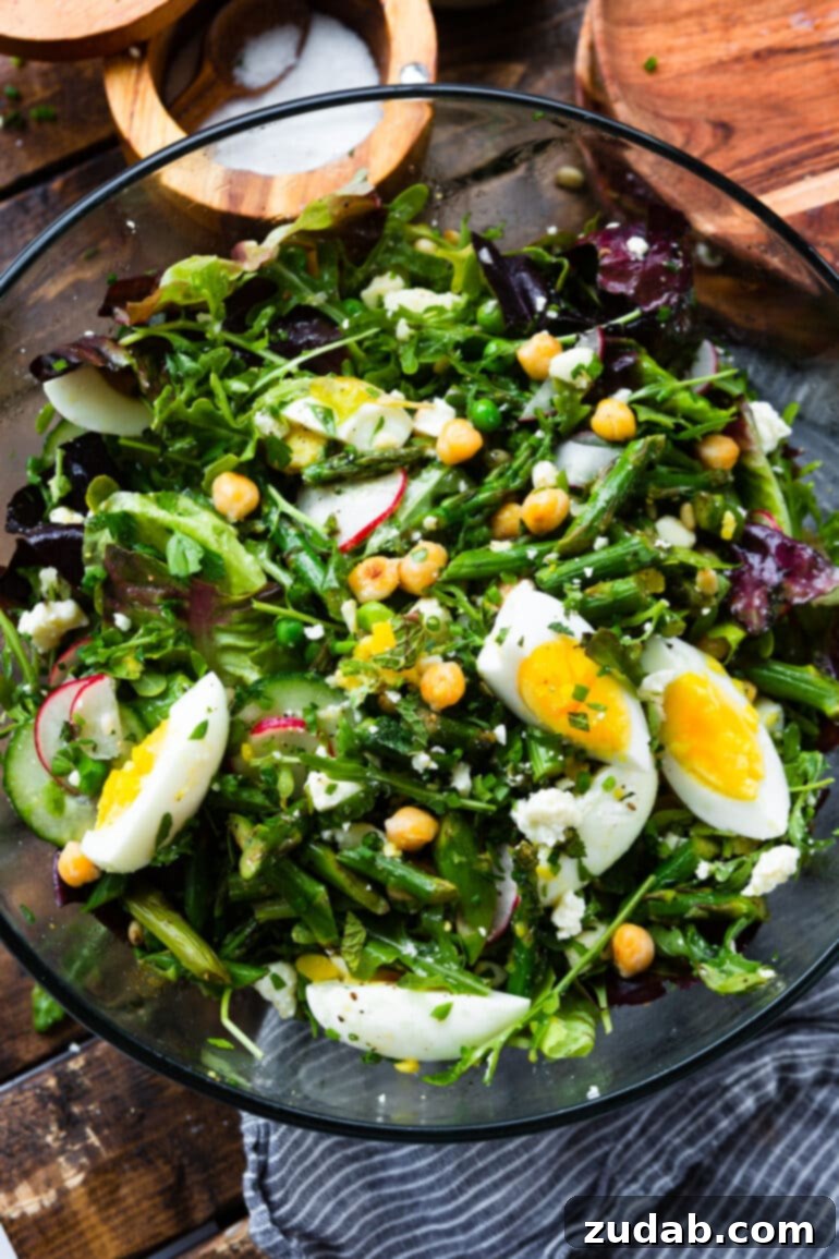 Effortless Springtime Greens 8 a photo of a large glass bowl full of a delicious spring salad.