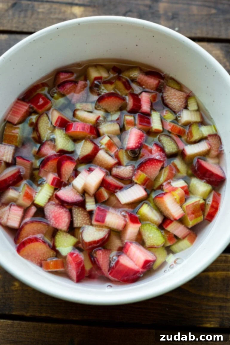 Sweet and Tart Rhubarb Cake 3 A photo of a large bowl full of chopped rhubarb soaking in water.