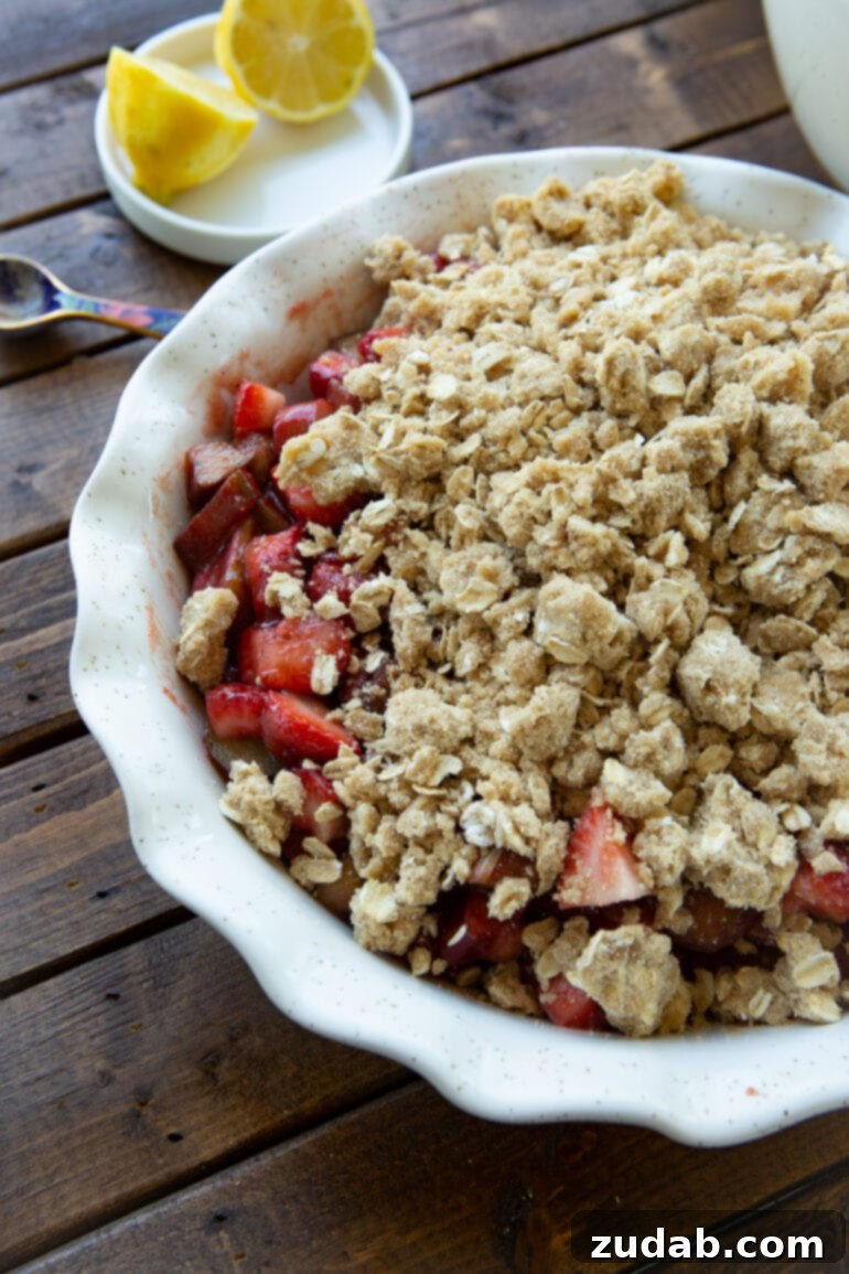 Golden Strawberry Rhubarb Crisp 4 A beautiful photo of an unbaked strawberry rhubarb crisp, featuring a generous, chunky buttery oat topping ready for the oven.