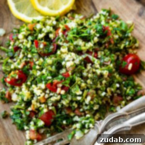 A vibrant, close-up shot of tabbouleh salad in a white bowl, showcasing the finely chopped herbs and plump bulgur, ready to be served.