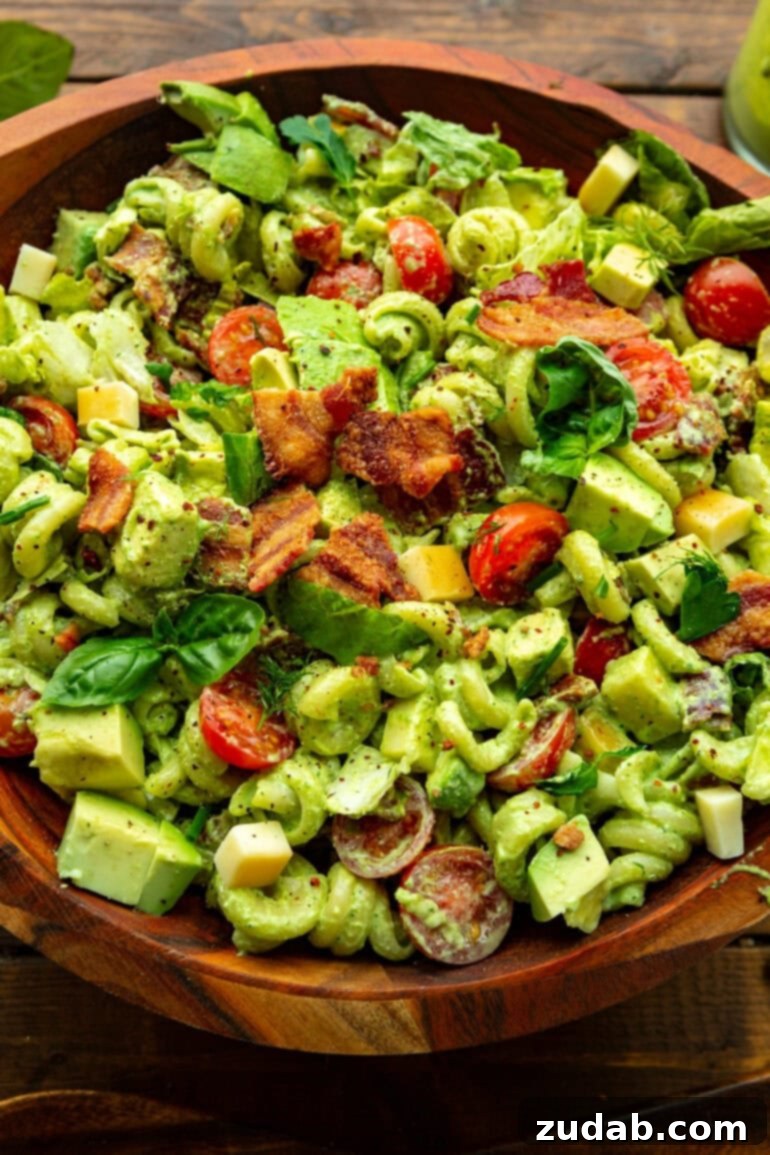Velvety Basil Dressing Quick And Healthy 3 A vibrant creamy BLT pasta salad served in a rustic wooden bowl, generously coated with the irresistible basil dressing.