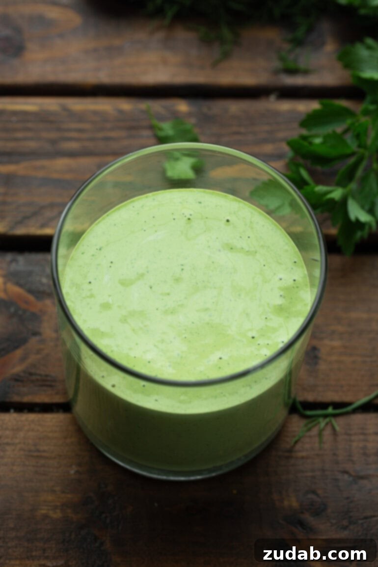 Velvety Basil Dressing Quick And Healthy 7 A close-up photo of a glass container filled with vibrant, creamy basil dressing, ready to add flavor to any dish.