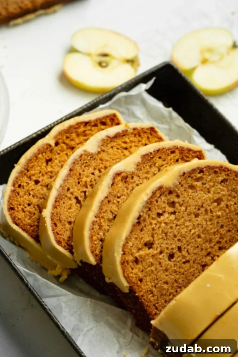 Irresistible Apple Bread with Brown Sugar Glaze 2 a photo of several slices of apple bread with brown sugar icing that have been sliced from a whole life laying on each other.