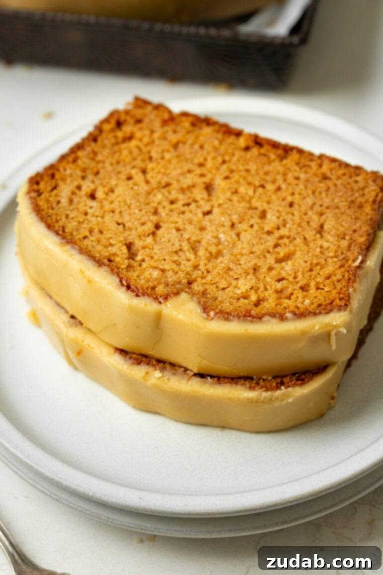Irresistible Apple Bread with Brown Sugar Glaze 7 a photo of two slices of homemade apple bread stacked on each other topped with brown sugar icing