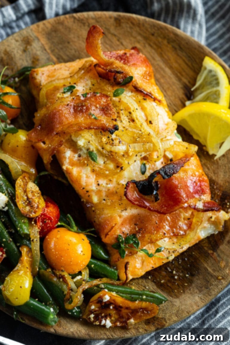 Golden Glazed Maple Bacon Mustard Salmon 2 A perfectly baked salmon fillet wrapped in crispy bacon and glazed with a glistening maple mustard sauce, ready to be served.