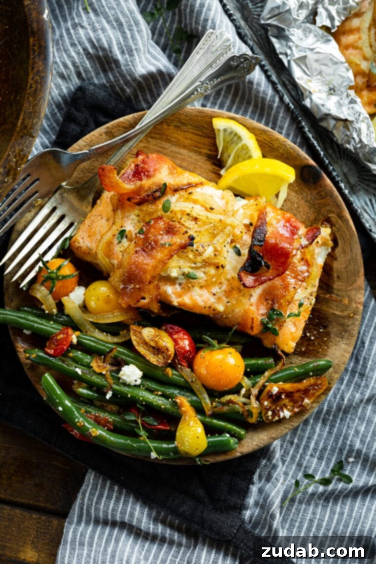 Golden Glazed Maple Bacon Mustard Salmon 4 A single baked maple mustard salmon fillet, wrapped in bacon, served on a rustic wooden plate with a side of sautéed green beans and cherry tomatoes for a healthy and flavorful dinner.