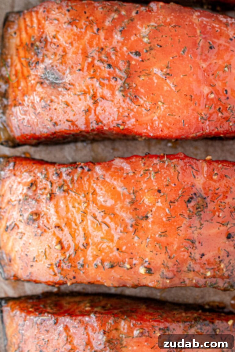 Perfect Smoked Salmon Recipe 5 a photo taken over the top of 3 beautifully glazed and smoked salmon fillets, glistening under the light