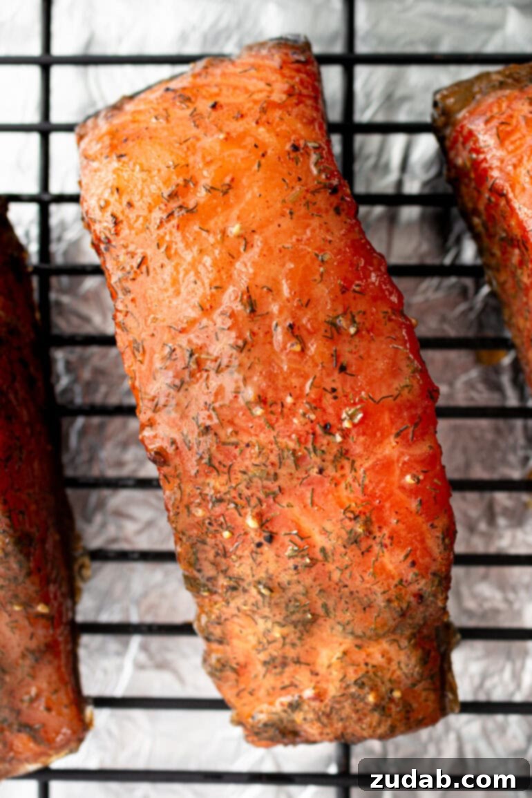 Perfect Smoked Salmon Recipe 10 a photo of a smoked salmon fillet sitting on a wire cooling rack, showcasing its golden-brown color and perfect glaze
