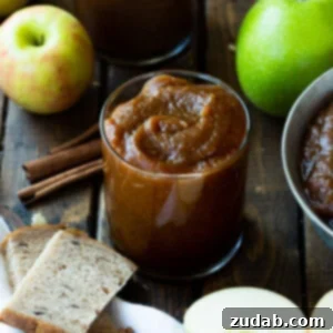 Hands-Off Slow Cooker Apple Butter 7 A vibrant, close-up image of rich, homemade apple butter in a jar, showcasing its smooth texture and inviting color.