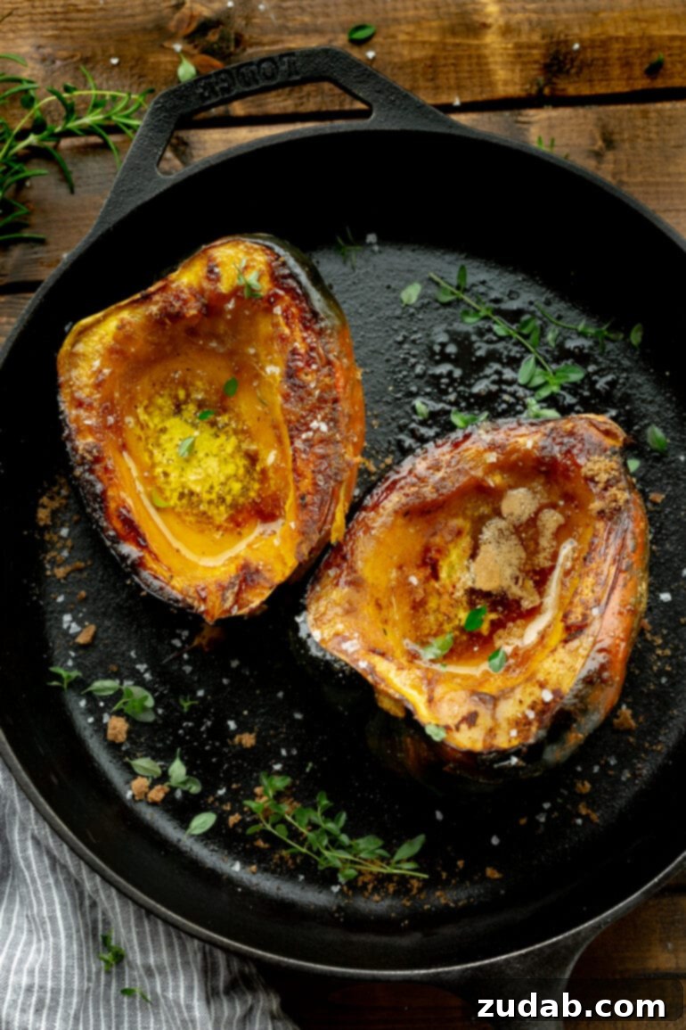 Brown Sugar Glazed Acorn Squash 4 A photo of an acorn squash that is halved and facing flesh side up, beautifully roasted and caramelized with brown sugar.