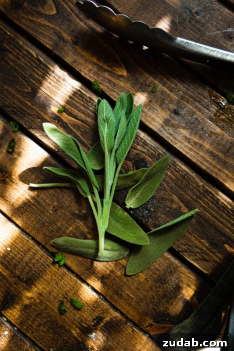 Festive Acorn Squash Delight 9 A charming photo of a fresh bundle of aromatic sage leaves resting gently on a rustic wooden table, highlighting their vibrant green color and inviting texture.