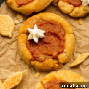 Pillowy Pumpkin Pie Cookies 10 A photo of several pumpkin pie cookies topped with a little dollop of whipped cream, for the recipe card.