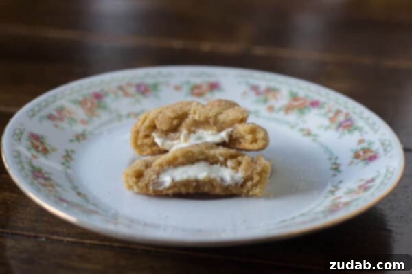 A close-up of a perfectly baked brown butter snickerdoodle, showcasing its crinkled top and soft texture.