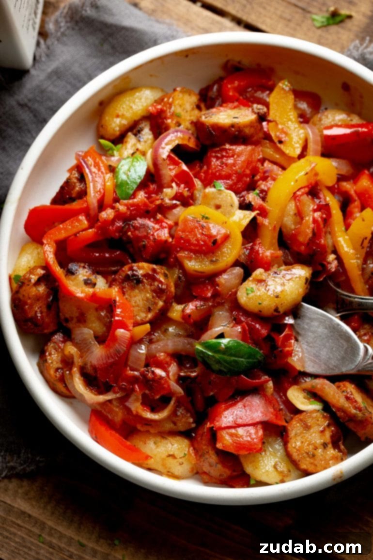 Weekly Menu Plan - Nov. 13 to 19 6 A generous white bowl filled with juicy and tender sausage and peppers gnocchi, bathed in a rich sauce and garnished with fresh herbs, showcasing a perfect weeknight meal.