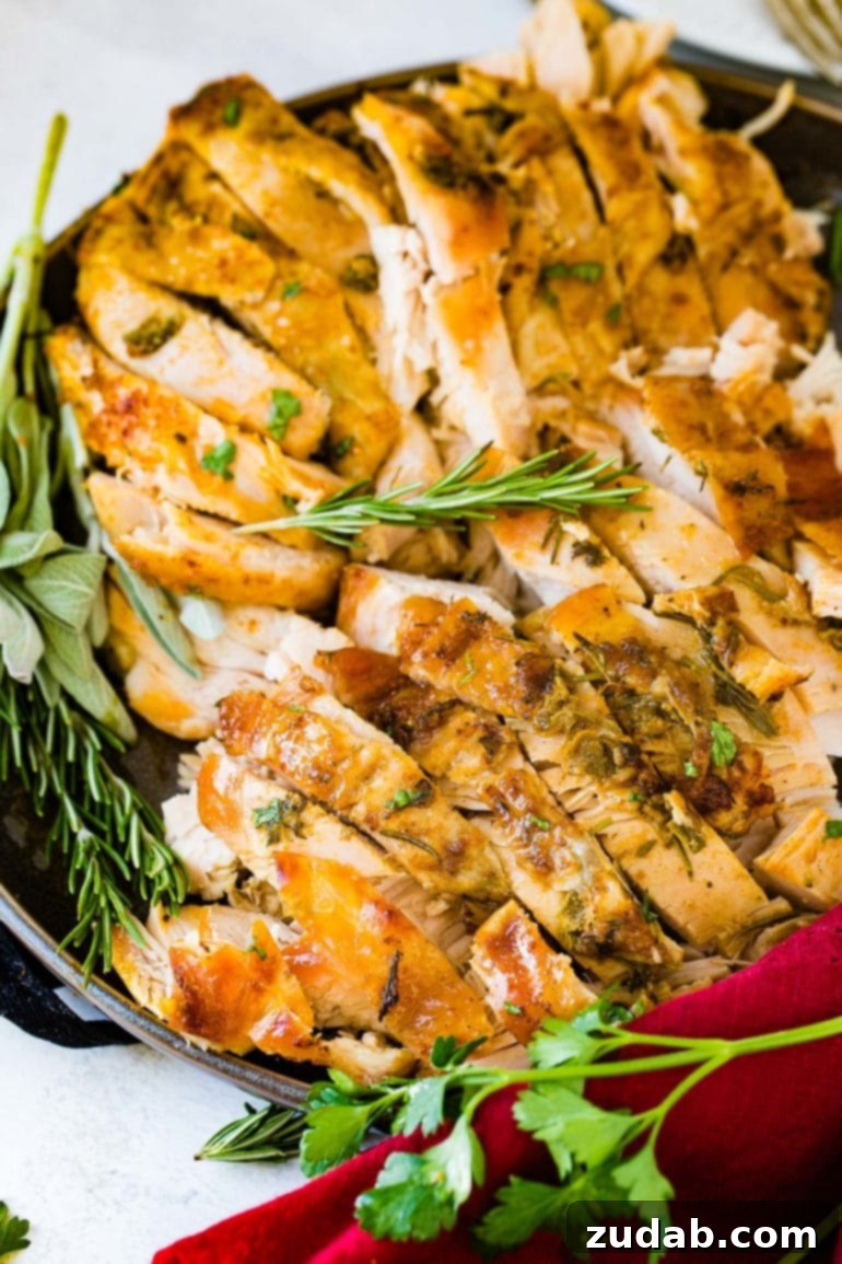 Weekly Meal Plan: November 20-26 6 Succulent, perfectly sliced slow cooker turkey breast, elegantly garnished with fresh sprigs of rosemary and thyme, resting on a serving platter.