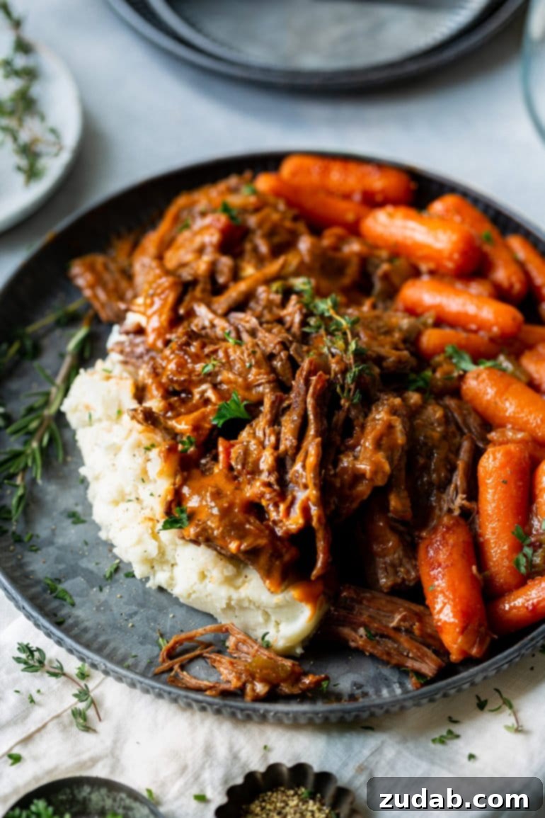 Weekly Meal Plan: November 27 - December 3 9 A plate generously piled with creamy mashed potatoes, topped with juicy, tender pot roast, and accompanied by a side of perfectly cooked carrots.