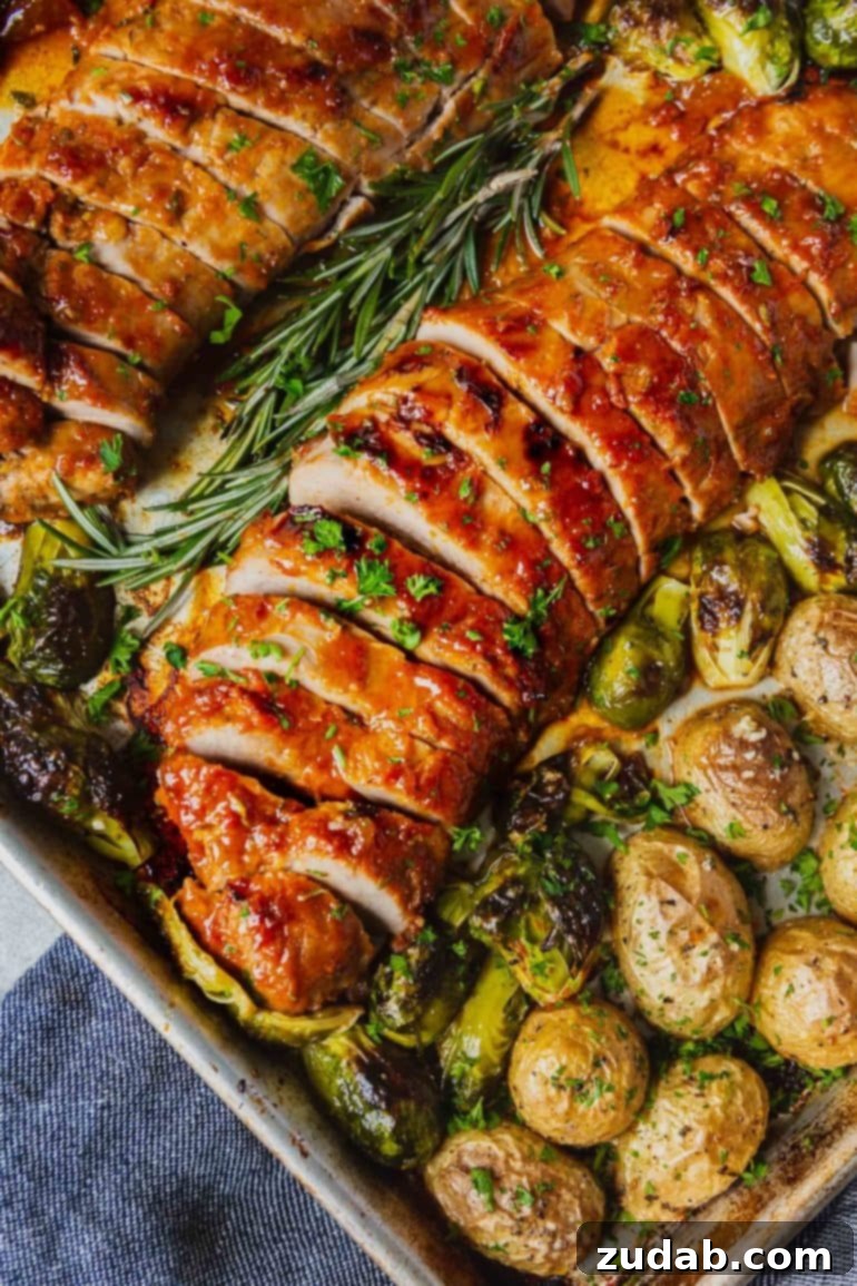 Savor the Week Meal Plan Dec 4-10 5 A vibrant sheet pan showcasing two perfectly glazed, roasted pork loins, skillfully sliced for serving, accompanied by tender roasted potatoes and crisp Brussels sprouts.