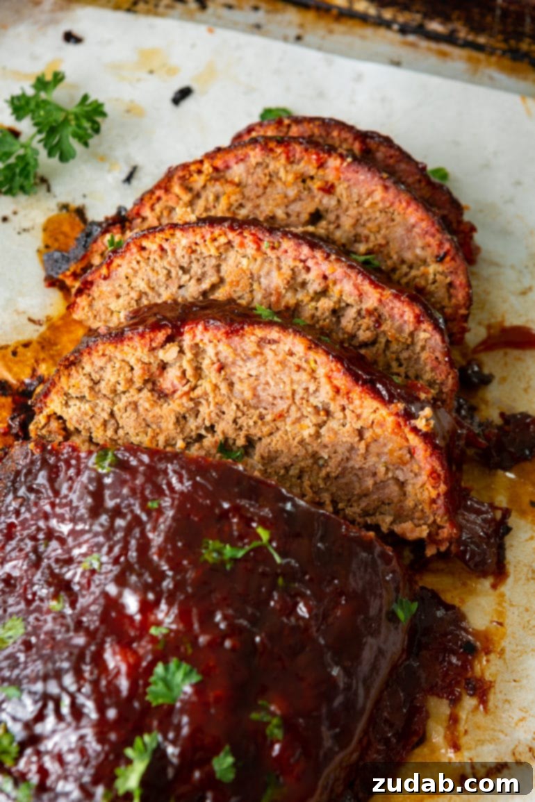 Savor the Week Meal Plan Dec 4-10 8 An overhead view of a perfectly smoked meatloaf, showcasing three slices expertly cut from one end, revealing a beautiful, vibrant smoke ring within, and garnished with a sprinkle of fresh chopped parsley.