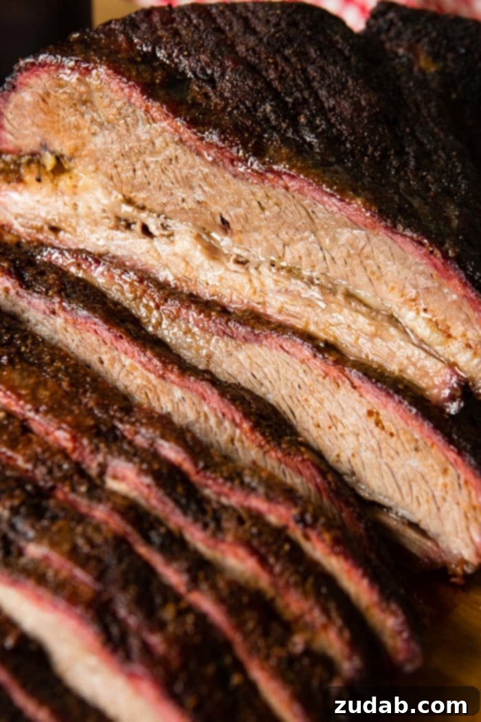 Weekly Meal Plan Dec 25 to 31 5 A stunning photo of perfectly smoked brisket, expertly sliced to reveal a prominent pink smoke ring and incredibly tender texture.