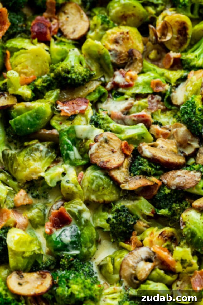 Luscious Garlic Parmesan Broccoli and Sprouts 4 A close-up of sautéed broccoli and Brussels sprouts, mingling with sliced mushrooms and golden crispy bacon bits, all glistening in a sauté pan before the creamy sauce is added.