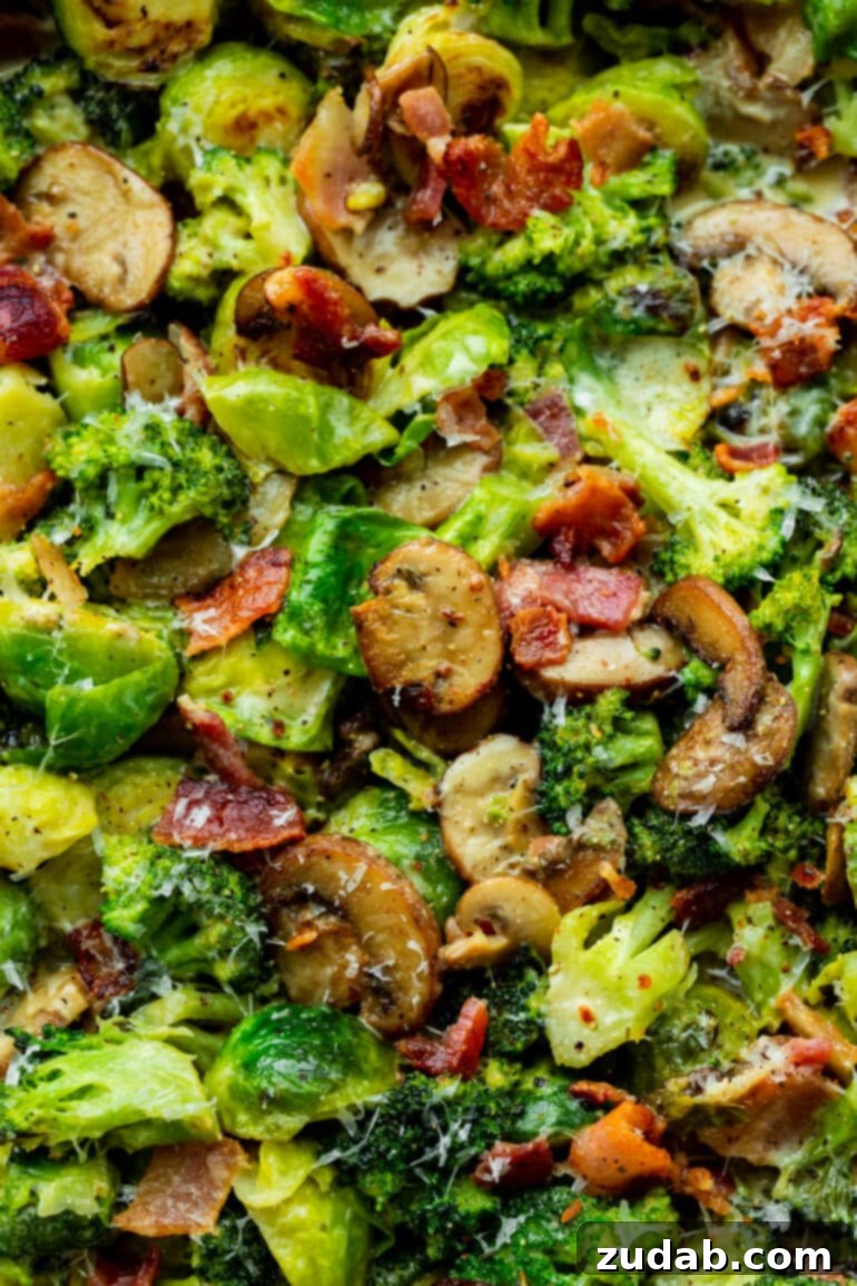 Luscious Garlic Parmesan Broccoli and Sprouts 6 A close-up photo of sautéed mushrooms, Brussels sprouts, and broccoli, perfectly coated in a creamy sauce with crispy bacon bits, showcasing the dish's enticing texture and vibrant colors.