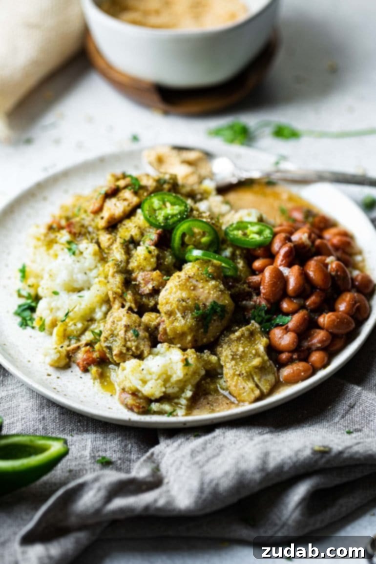 Weekly Menu Plan: January 22-28 5 A generous serving of vibrant green chicken chile verde, topped with pinto beans and fresh cilantro, presented over a bed of white rice in a rustic bowl, perfect for a hearty dinner.
